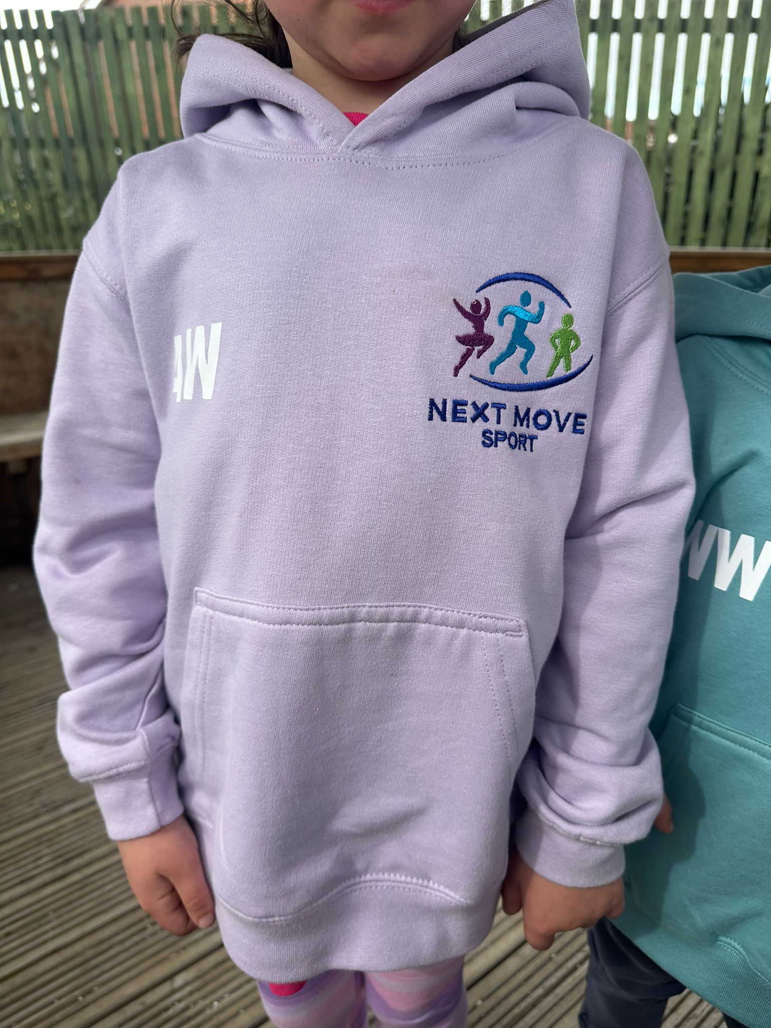 Girl wearing a lavender Next Move hoodie